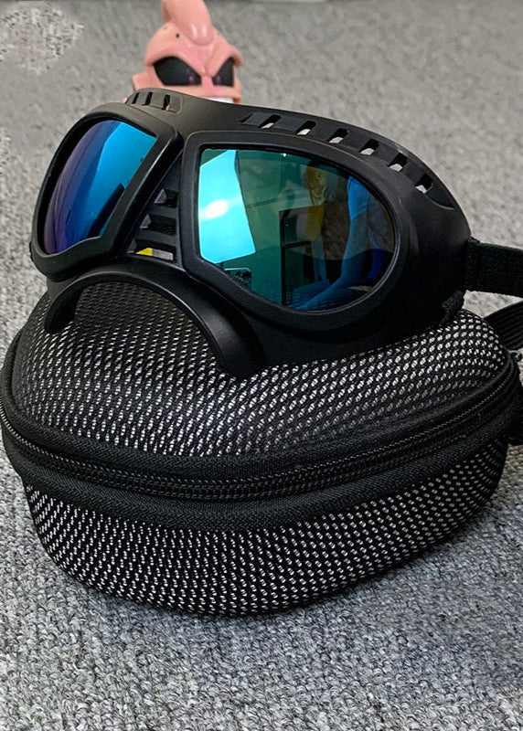Black windproof motorcycle goggles with blue reflective lenses resting on a textured black zippered case