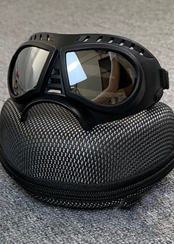 Windproof motorcycle goggles with black frame and tinted lenses on a textured protective case